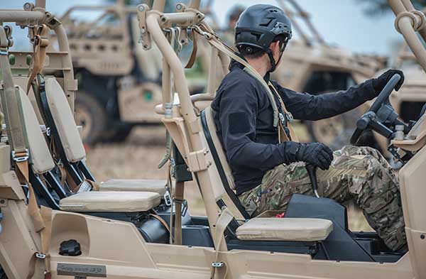 A soldier drives a light vehicle