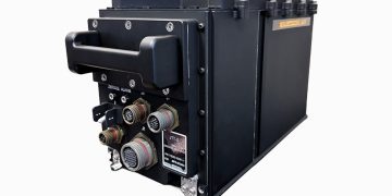 JTT-X electronic module with a rugged black housing, carrying handle, and multiple electrical connectors displayed against a white background.
