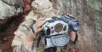 A soldier looks into a Joint Effects Targeting System (JETS)
