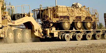 An M1000 carries an armored vehicle.