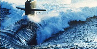 A submarine powers through waves